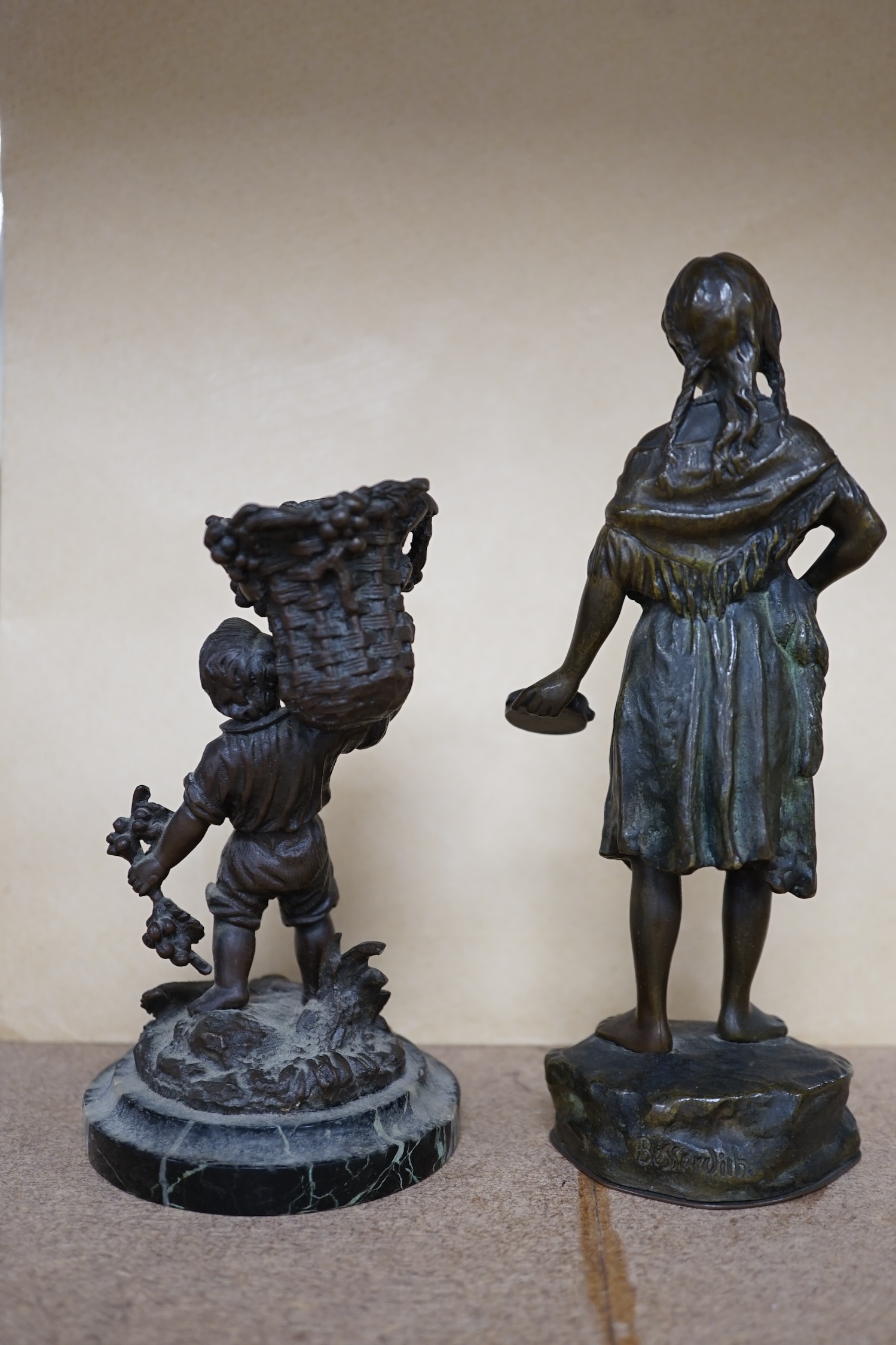 A bronze study of a girl holding a tambourine, and a bronze boy carrying grapes, raised on marble base, largest 16cm high. Condition - good